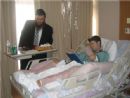 Rabbi Yosef Chaim Kantor dons tefillin with a survivor
