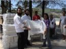 Presenting beach chairs to a victim to restart her business